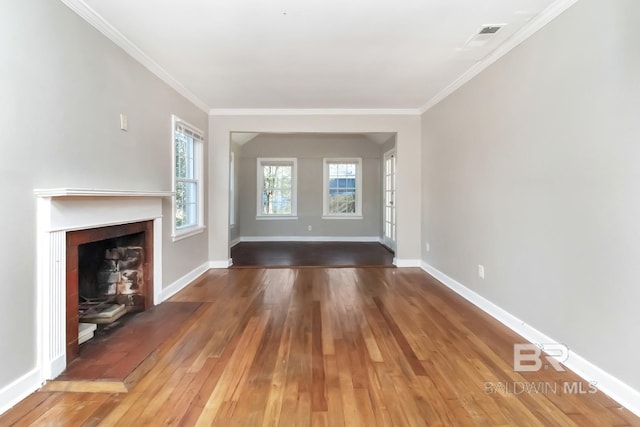 unfurnished living room with ornamental molding, a fireplace with flush hearth, baseboards, and hardwood / wood-style flooring