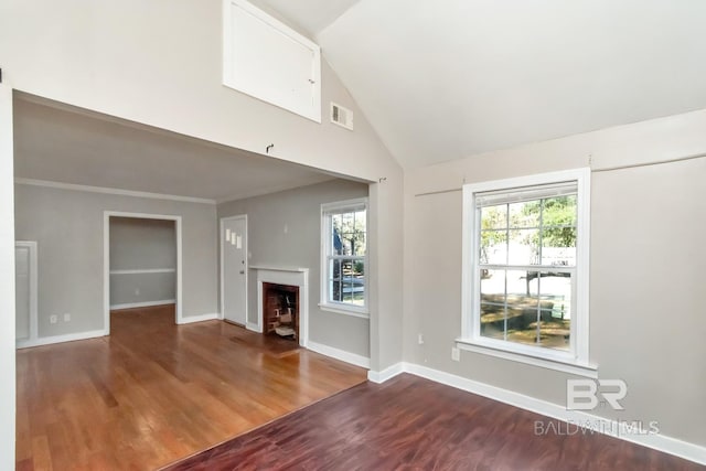 unfurnished living room with high vaulted ceiling, a fireplace, wood finished floors, visible vents, and baseboards