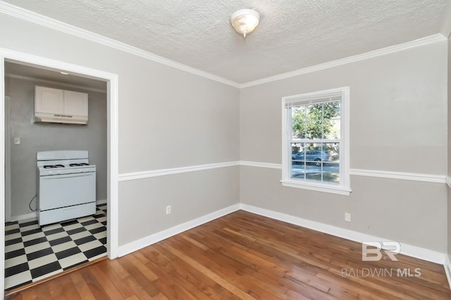 unfurnished dining area featuring a textured ceiling, baseboards, wood finished floors, and ornamental molding