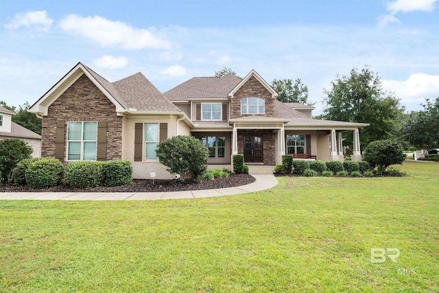 craftsman inspired home featuring covered porch and a front yard