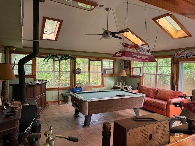 rec room featuring ceiling fan, vaulted ceiling with skylight, light tile patterned floors, and billiards