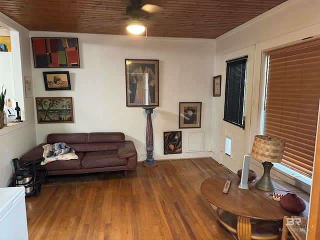 living room with wooden ceiling, ceiling fan, wood-type flooring, and ornamental molding