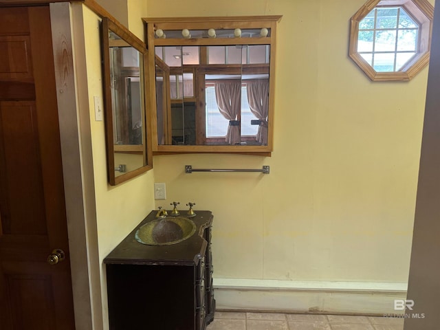 bathroom with tile patterned flooring and vanity