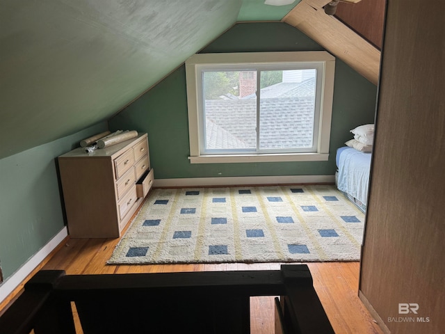 bonus room featuring vaulted ceiling and light hardwood / wood-style flooring