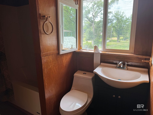 bathroom featuring vanity, a healthy amount of sunlight, and toilet