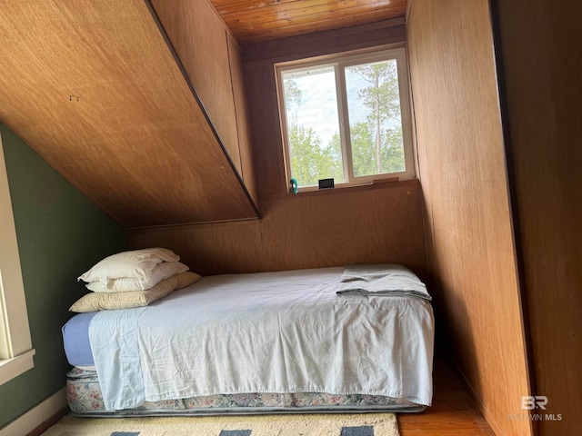 bedroom with wooden ceiling, vaulted ceiling, and wood-type flooring