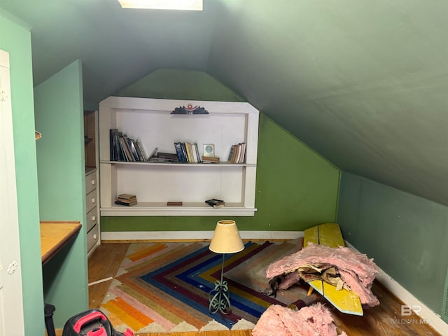 bedroom with lofted ceiling and hardwood / wood-style flooring