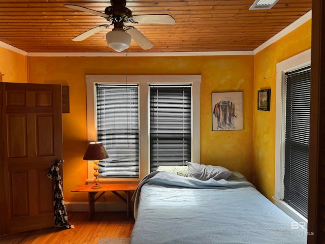 bedroom featuring ceiling fan, light wood-type flooring, crown molding, and wooden ceiling