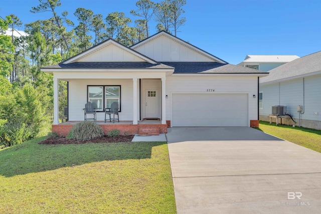 5774 Ono Ave, Pensacola, FL 32507 - ranch-style house featuring board and batten siding, a garage, covered porch, concrete driveway, and a front yard