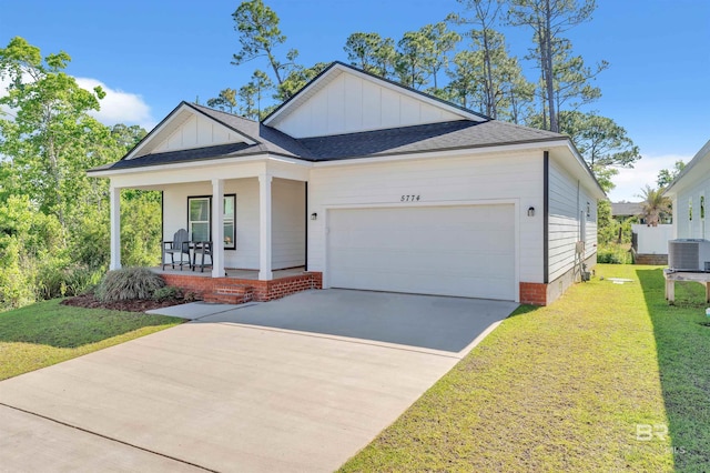 5774 Ono Ave, Pensacola, FL 32507 - view of front facade with a porch, central AC unit, a front yard, and board and batten siding