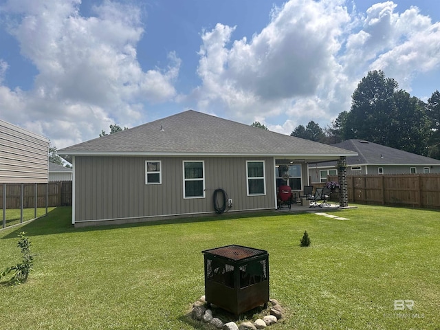 back of house featuring a yard and a patio area