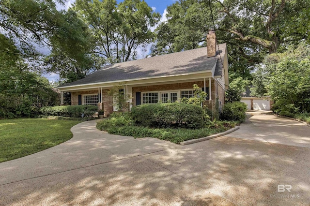 52 N Hawthorne Pl, Mobile, AL 36608 - view of front of house featuring brick siding, a chimney, a front lawn, and a garage