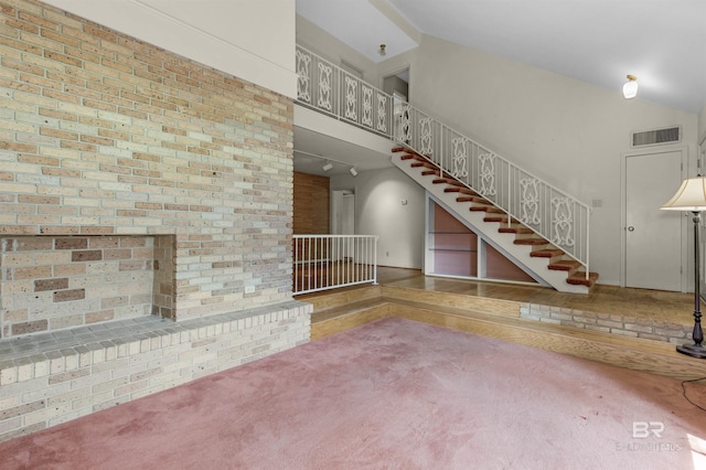 52 N Hawthorne Pl, Mobile, AL 36608 - unfurnished living room featuring stairway, carpet floors, and lofted ceiling