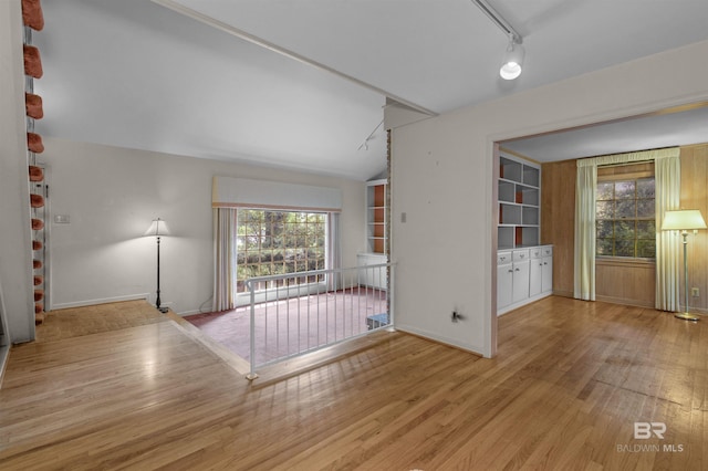 52 N Hawthorne Pl, Mobile, AL 36608 - empty room with wood finished floors, baseboards, and lofted ceiling