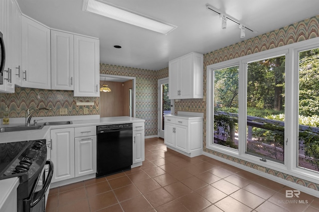52 N Hawthorne Pl, Mobile, AL 36608 - kitchen with black appliances, wallpapered walls, a sink, rail lighting, and light countertops