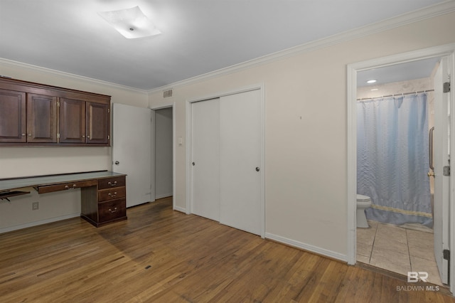 52 N Hawthorne Pl, Mobile, AL 36608 - unfurnished office featuring light wood-style flooring, crown molding, built in study area, and baseboards