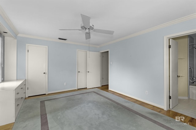 52 N Hawthorne Pl, Mobile, AL 36608 - unfurnished bedroom with light wood-style flooring, crown molding, baseboards, a ceiling fan, and multiple closets