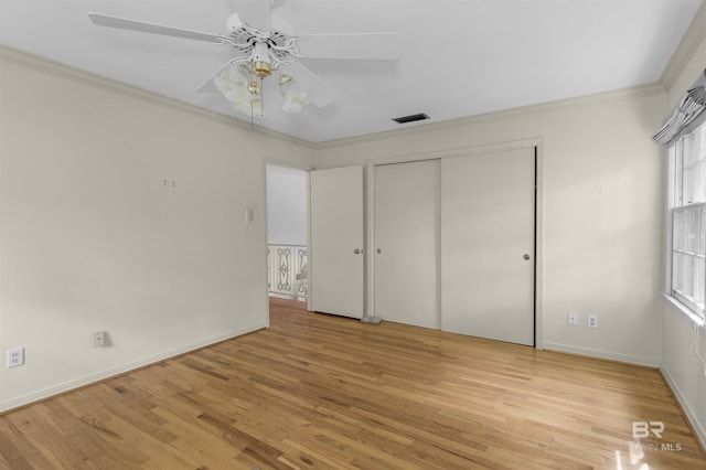 52 N Hawthorne Pl, Mobile, AL 36608 - unfurnished bedroom with light wood finished floors, ornamental molding, a closet, and baseboards