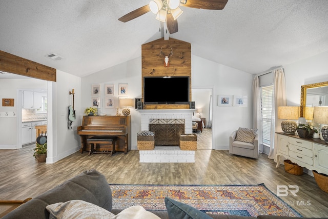 117 Richmond Rd, Daphne, AL 36526 - living room with ceiling fan, wood finished floors, a textured ceiling, baseboards, and a fireplace