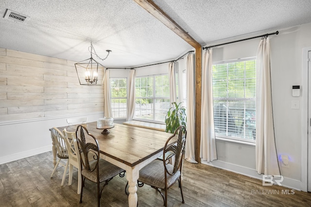 117 Richmond Rd, Daphne, AL 36526 - dining space with a textured ceiling, healthy amount of natural light, wood finished floors, and wood walls