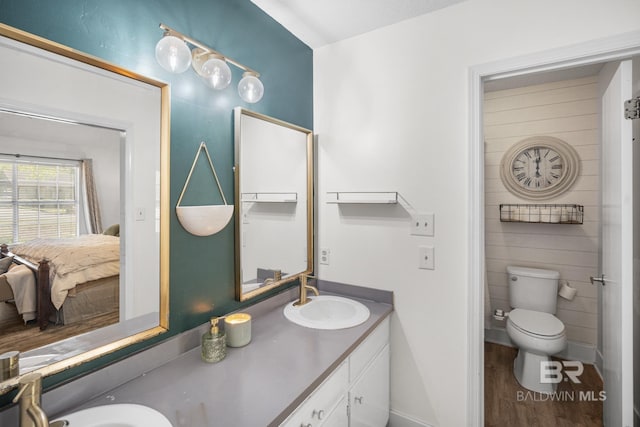 117 Richmond Rd, Daphne, AL 36526 - ensuite bathroom featuring wood finished floors, toilet, vanity, and baseboards