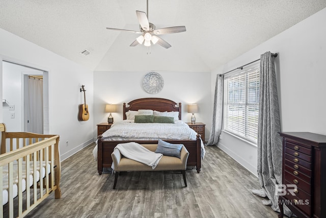 117 Richmond Rd, Daphne, AL 36526 - bedroom with lofted ceiling, wood finished floors, baseboards, a textured ceiling, and a ceiling fan