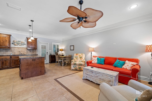 tiled living room featuring ceiling fan and ornamental molding