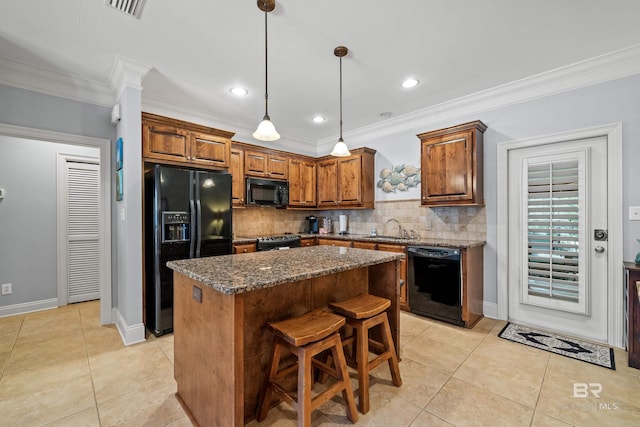 kitchen with a center island, black appliances, sink, dark stone countertops, and tasteful backsplash