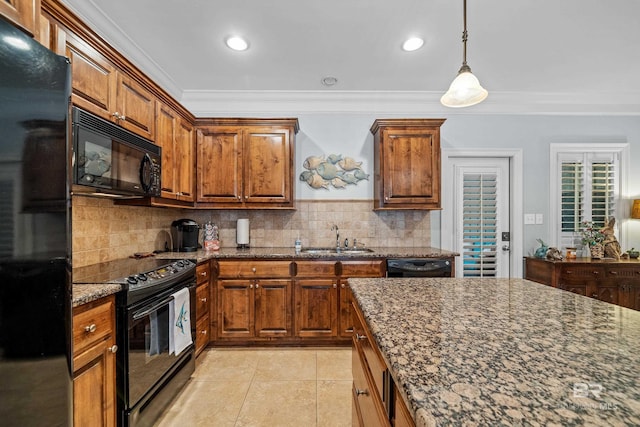 kitchen featuring dark stone counters, decorative backsplash, black appliances, and ornamental molding