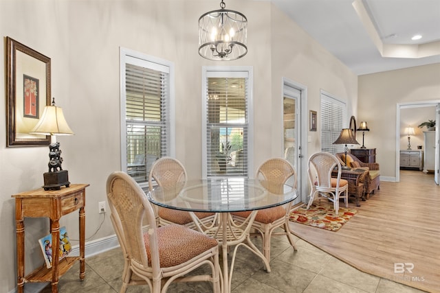 tiled dining space featuring a chandelier