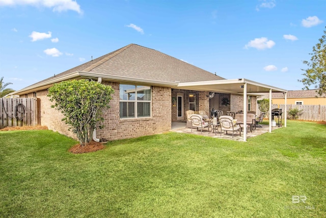 rear view of house with a yard and a patio area