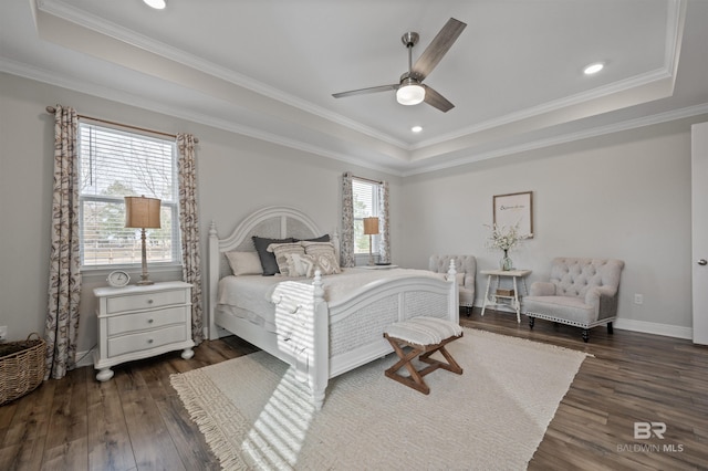 bedroom featuring a raised ceiling, ornamental molding, dark hardwood / wood-style floors, and ceiling fan