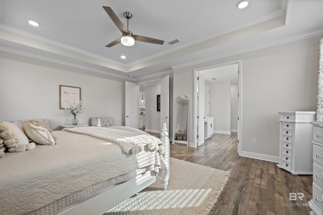 bedroom with dark hardwood / wood-style flooring, a tray ceiling, ornamental molding, and ceiling fan