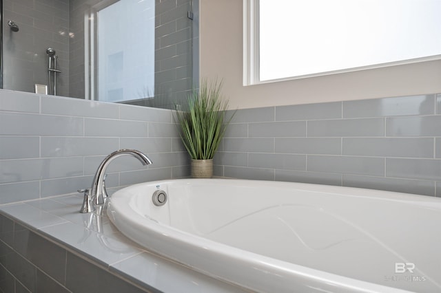 bathroom featuring tiled bath