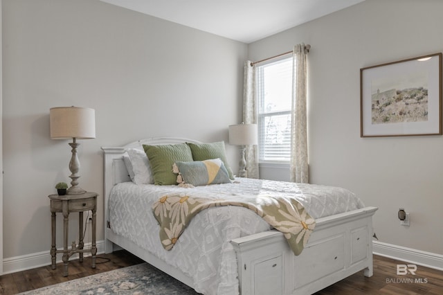 bedroom with dark hardwood / wood-style flooring