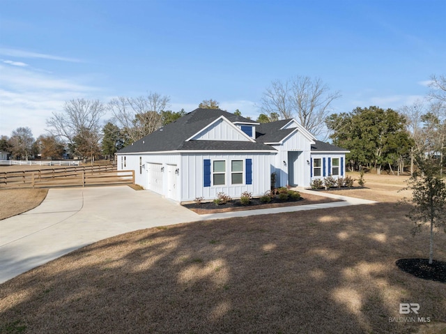 view of front of property with a garage and a front lawn