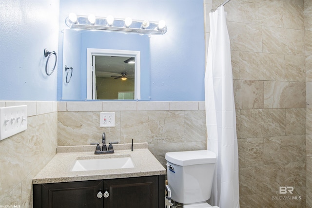 9005 Tuscaloosa Dr, Perdido Beach, AL 36530 - full bath featuring toilet, tile walls, a ceiling fan, a tile shower, and vanity
