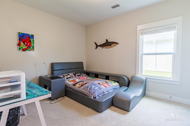 carpeted bedroom featuring visible vents, baseboards, and multiple windows
