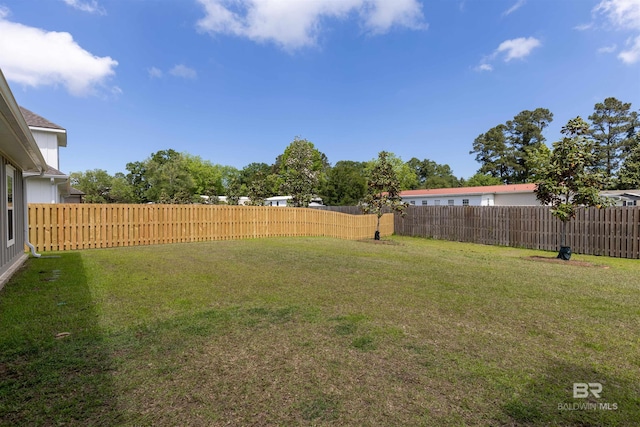 view of yard with a fenced backyard