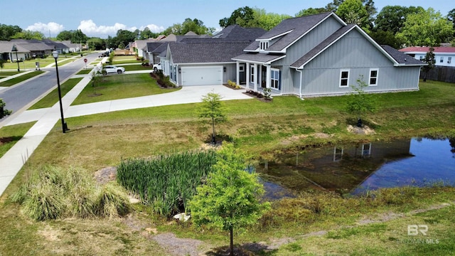 exterior space featuring concrete driveway, board and batten siding, a front yard, and a garage