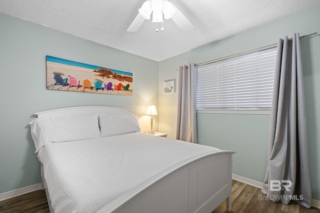 bedroom featuring a textured ceiling, ceiling fan, and dark hardwood / wood-style floors