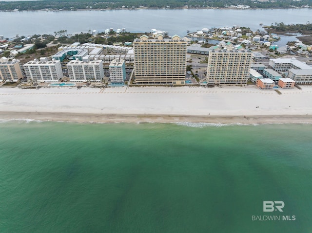 drone / aerial view featuring a water view and a beach view