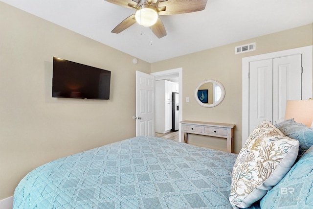 bedroom featuring a closet, ceiling fan, and light hardwood / wood-style flooring