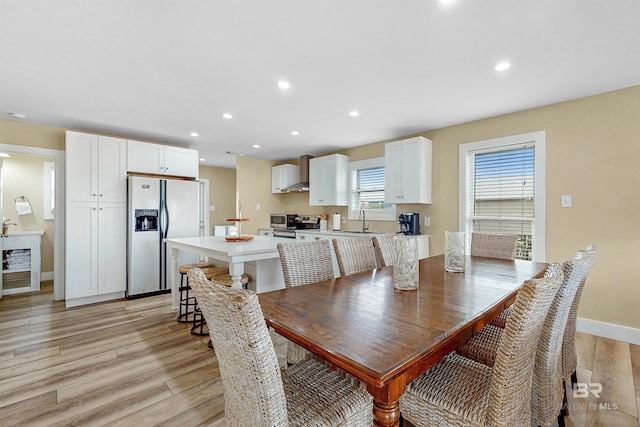 dining area featuring sink and light hardwood / wood-style flooring