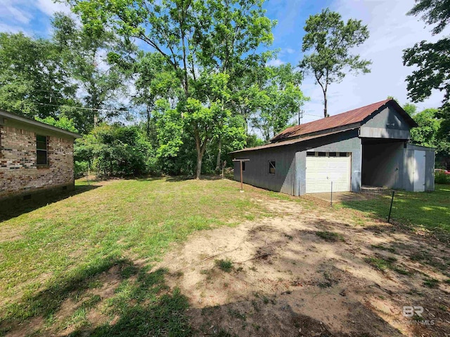 view of yard featuring a garage and an outdoor structure