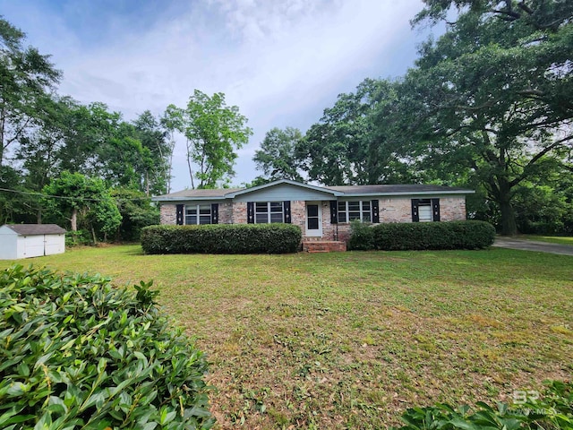 ranch-style house with an outdoor structure and a front lawn