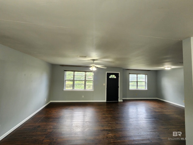 empty room featuring dark hardwood / wood-style floors and ceiling fan