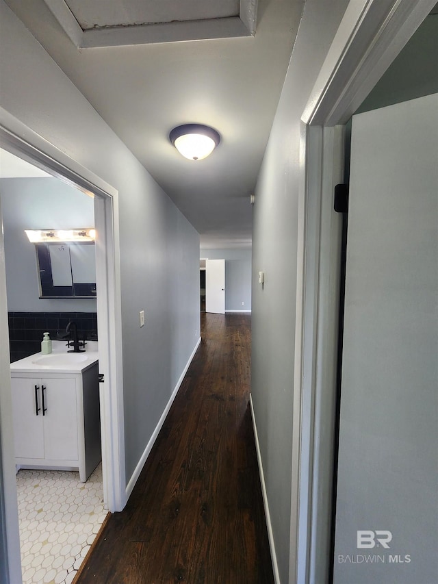 corridor featuring dark hardwood / wood-style floors and sink