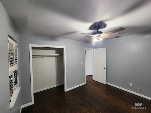 unfurnished bedroom with a closet, ceiling fan, and dark hardwood / wood-style flooring