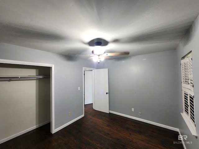 unfurnished bedroom featuring dark hardwood / wood-style flooring, a closet, and ceiling fan